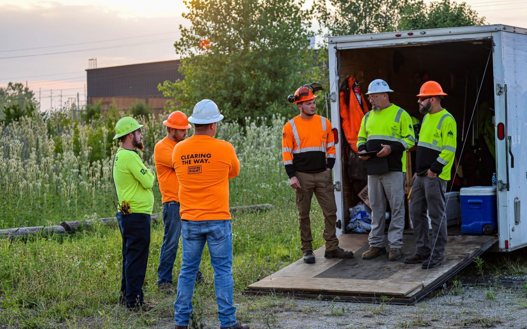 Group of men communicating on the back of a trailer.