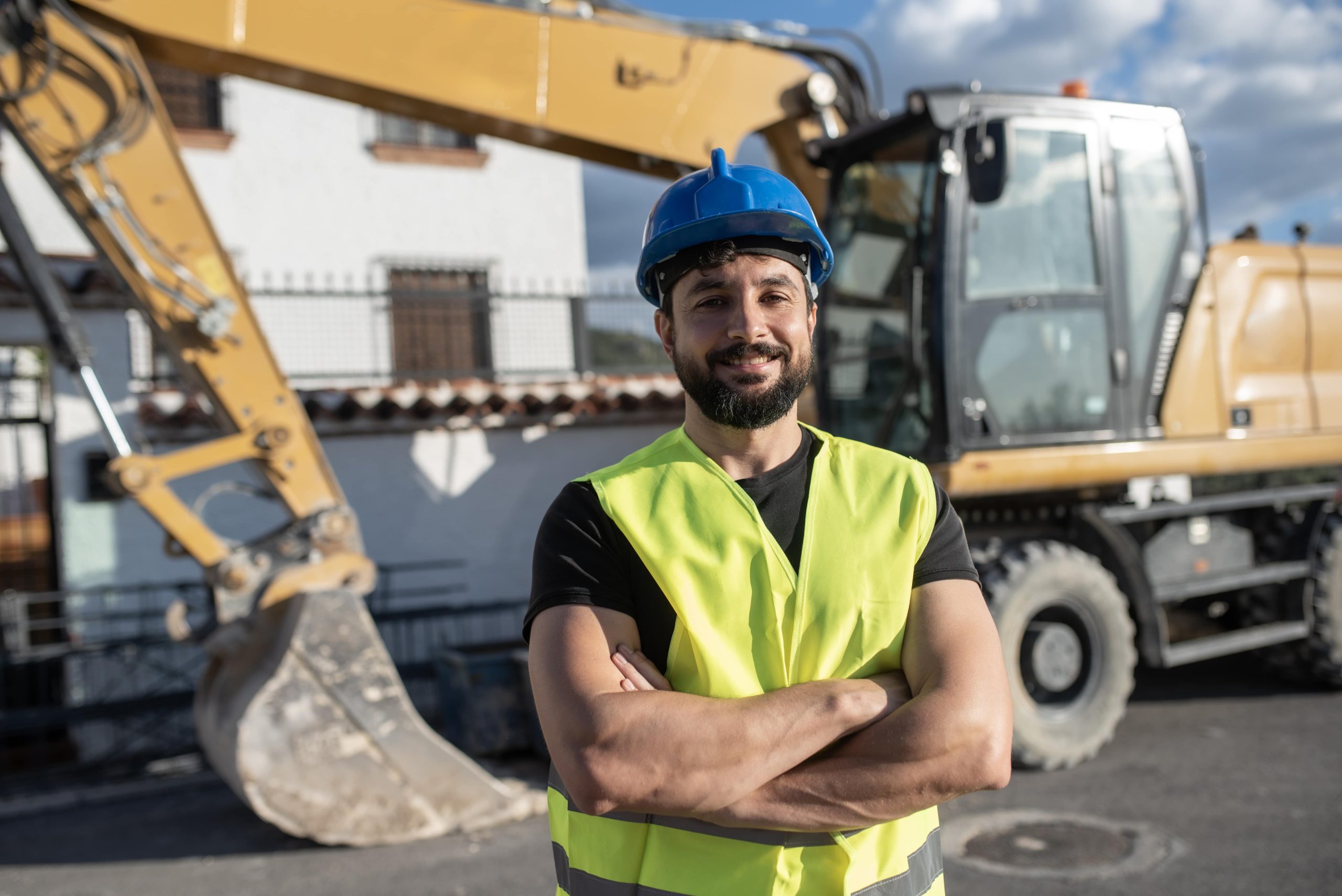 How Leading by Example Affects Company Culture Construction worker man portrait outdoors, backhoe bulldozer in background, landscaping and lawn care industry
